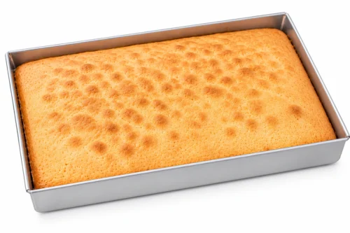 Rectangle cake tin with freshly baked sponge cake in aluminium baking tin